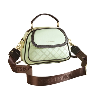 Minimalist mint green and coffee bucket bag with diamond quilting and wide shoulder strap