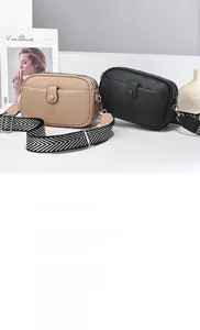 Detail of lychee pattern PU leather bags with stylish wave strap and zip layers