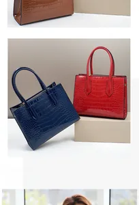Close-up of crocodile embossed textures on luxury handbags in navy, red, and brown colors