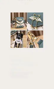 Detail of square crossbody bag with swan heart clasp, bear charm and woven strap