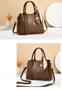 Detail of vintage brown leather handbag with geometric stitching and decorative silk scarf