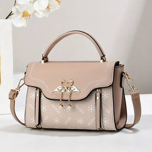 Fashionable nude pink flap handbag with swan buckle and elegant floral embroidery details
