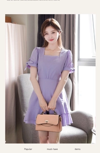 Detailed shot of an apricot litchi-grain leather handbag with a bow-sleeve purple dress