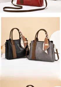Three elegant handbags in red, black, and grey with textured leather and fashion silk scarf