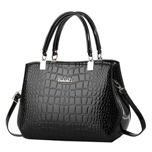 Elegant black glossy crocodile pattern handbag with golden hardware and top handles