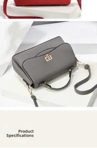 Close-up of litchi texture leather shoulder bag with metal lock and slim strap