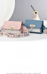 Close-up of pink and blue quilted crossbody bags featuring floral heart metal buckles