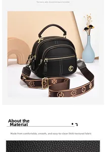 Close-up of black lychee grain leather crossbody bag with triple zippers and woven strap