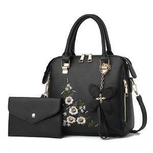 Elegant black leather handbag set with floral embroidery and gold hardware