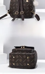Detail view of the vintage brown leather backpack back panel and reinforced bottom studs
