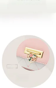 Detail of pink and white quilted PU leather bag with heart-shaped floral metal buckle