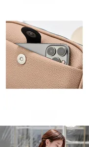 Detail of lychee textured crossbody bag with magnetic pocket for smartphone storage