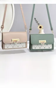 Detail of heart-quilted crossbody bags featuring ornate floral heart clasps in green and beige