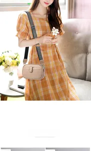 Detail of minimalist cream crossbody bag with textured leather and chevron wide strap