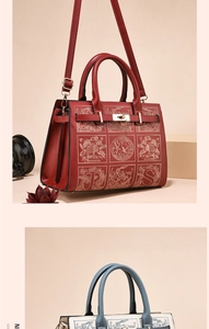 Detailed view of red textured PU leather handbag with embroidery and gold metal lock