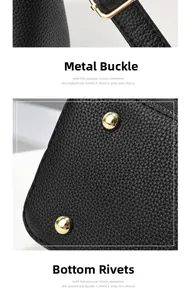 Detail of golden metal clasp and protective bottom rivets on black leather bag