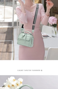 Detail of mint green lychee leather handbag with geometric patterned wide strap