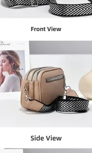 Detail view of beige three-layer zipper crossbody bag with textured leather and wide strap