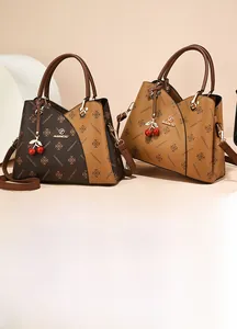 Detail of lychee pattern leather tote bag with JANENOVO print and cherry charm