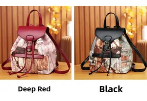 Detail view of burgundy and black vintage canvas backpacks with drawstring and metal buckles