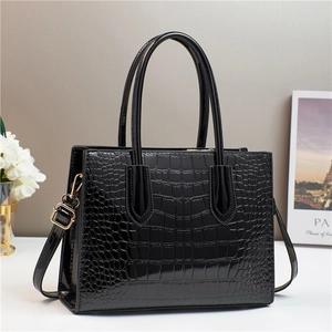 Glossy black crocodile pattern tote bag with top handles and adjustable shoulder strap