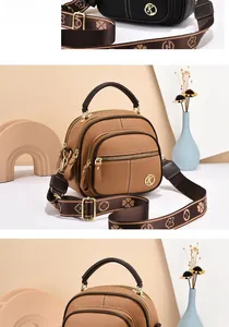 Close-up of brown litchi grain leather bag with golden K logo and wide printed strap