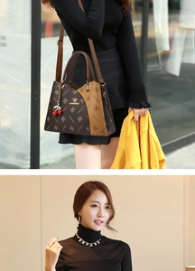 Detail of vintage monogram shoulder bag with cherry pendant and adjustable strap
