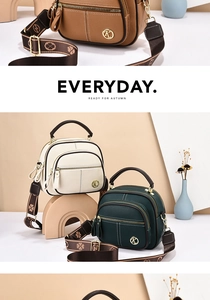 Detail of lychee pattern leather bags with floral straps and metal logo hardware