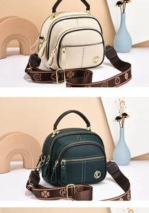 Detail view of multi-layer zipper crossbody phone bags in cream and dark green colors