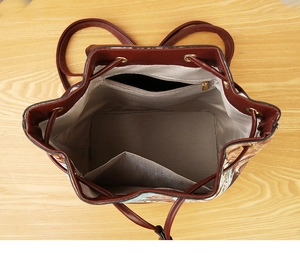 Interior view of vintage backpack featuring a main compartment with zipper and slip pockets