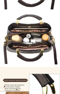 Detail of multi-compartment interior storage and golden hardware on top handle bag