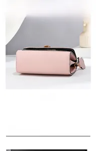 Detailed bottom view of pink crossbody bag showing precise stitching and side gusset design
