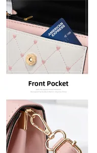 Detail of pink heart-quilted crossbody bag showing the front pocket and metal hardware