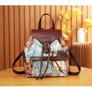 Detail of vintage canvas backpack with brown leather flap and magnetic buckle closure
