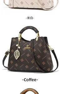 Detail showing printed faux leather texture, golden metal handle and pearl leaf charm