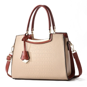 Elegant beige croc-embossed leather tote bag with dark brown handles and shoulder strap