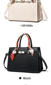 Detail of elegant handbags with silk scarf wrapped handle and metal twist lock