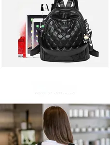 Detail of black quilted leather backpack with hello charm showing internal tablet storage