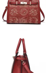 Detail of red leather handbag featuring exquisite floral embroidery and metal twist lock