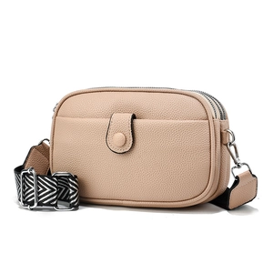 Three-layer beige pebbled leather crossbody bag with wide geometric woven strap