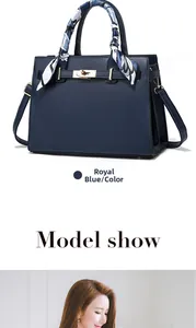 Royal blue structured handbag with golden twist lock and printed silk scarf on handle