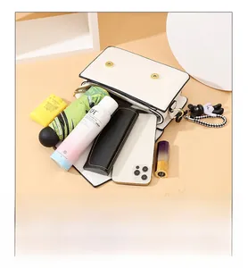 Detailed interior of the white leather crossbody bag showing large storage capacity