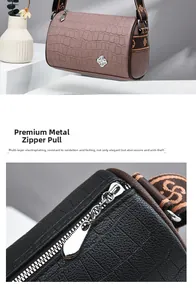 Detail of multi-layer plated metal zipper and crocodile textured leather on barrel bag