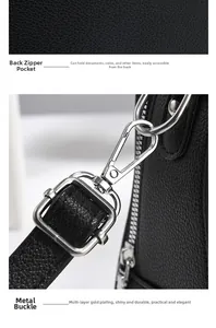 Detail of black pebbled leather handbag with secure back zipper pocket and silver metal clasp