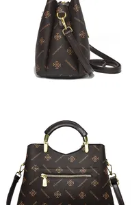 Macro detail of brown tote bag with clover print, gold hardware and metal handle
