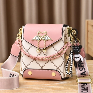 Pink and beige crossbody bag with quilted pattern, swan buckle and pearl detail