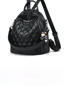 Detail of quilted black PU leather travel backpack with silver zippers and side strap