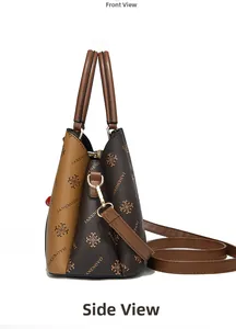 Detail view of the brown textured leather surface with golden hardware and brand patterns