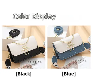 Détail de sacs carrés bicolores avec surpiqûres en cœur et boucle cygne en perles