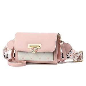 Pink and white quilted crossbody bag with golden heart clasp and floral wide strap